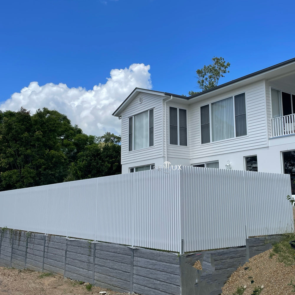 Two-story house with a white 40x40 batten fence