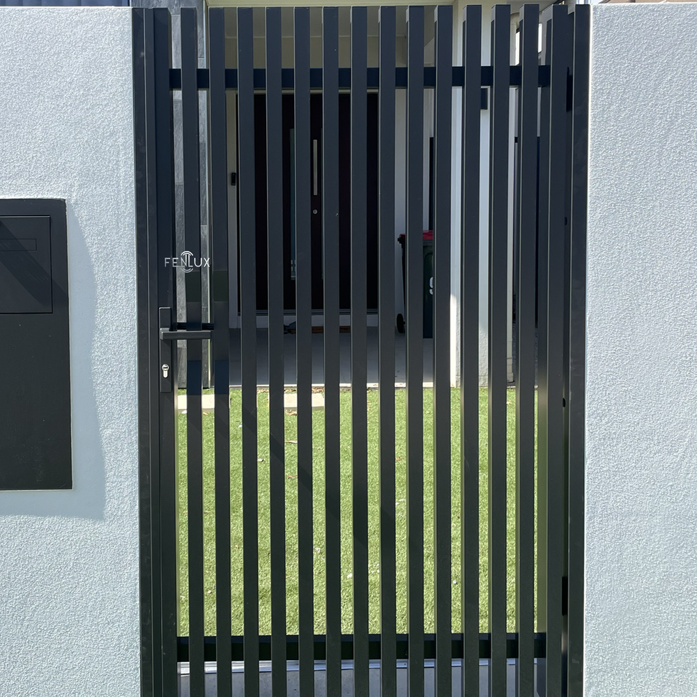 vertical batten garden gate with brick wall