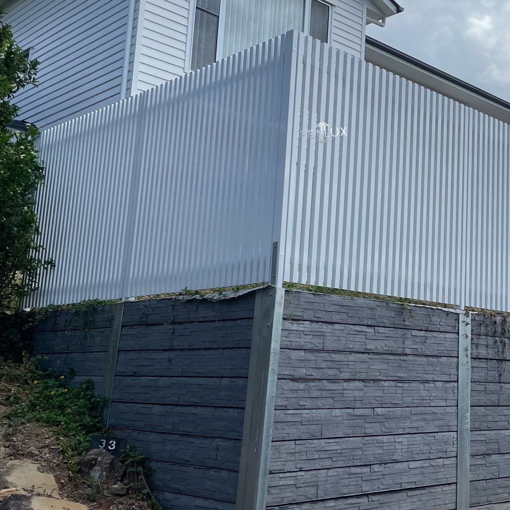 White batten fence with concrete sleeper wall